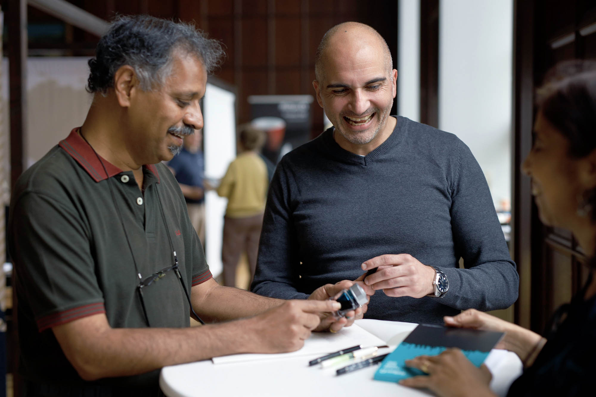 Three People looking at fountain pens